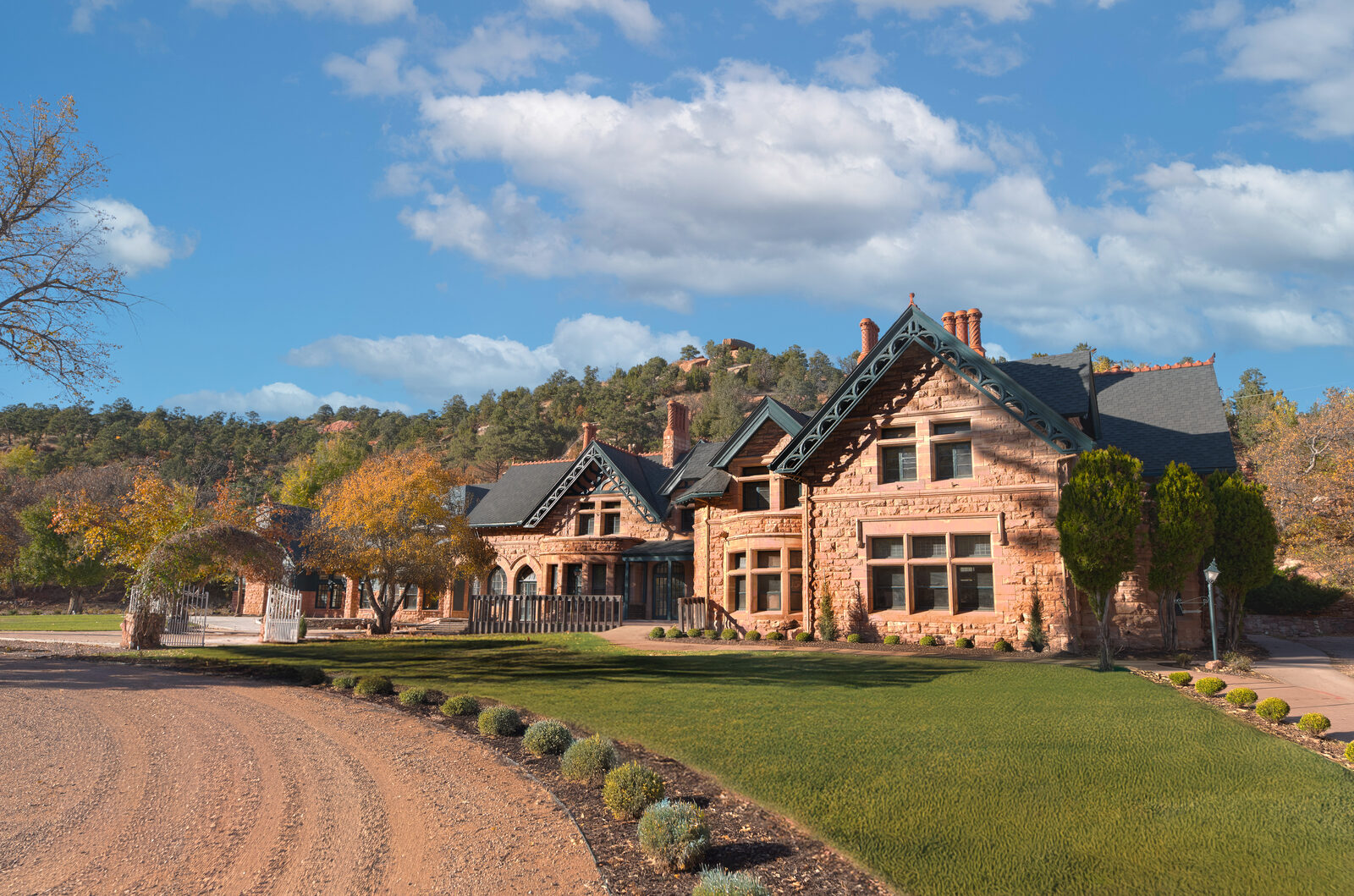 The historic stone façade of Briarhurst Manor with the Manitou Springs foothills behind