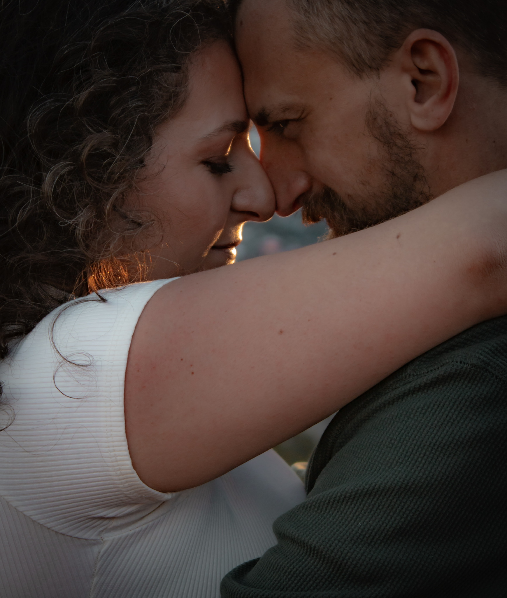 Adam and Emirjeta, forehead to forehead at sunset