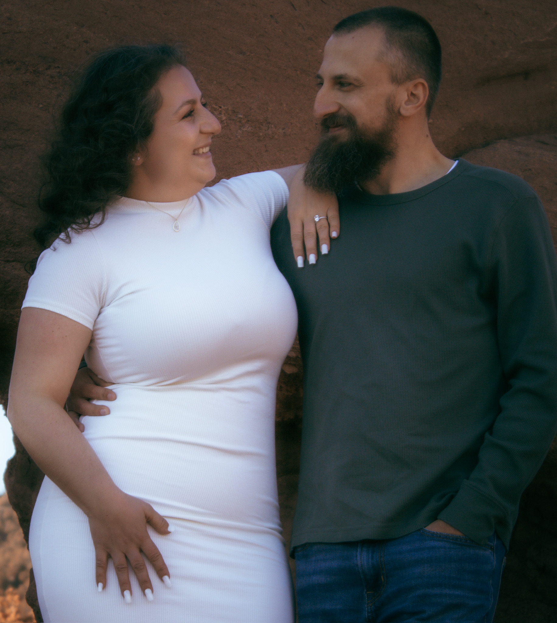 Adam and Emirjeta laughing together against the red rocks