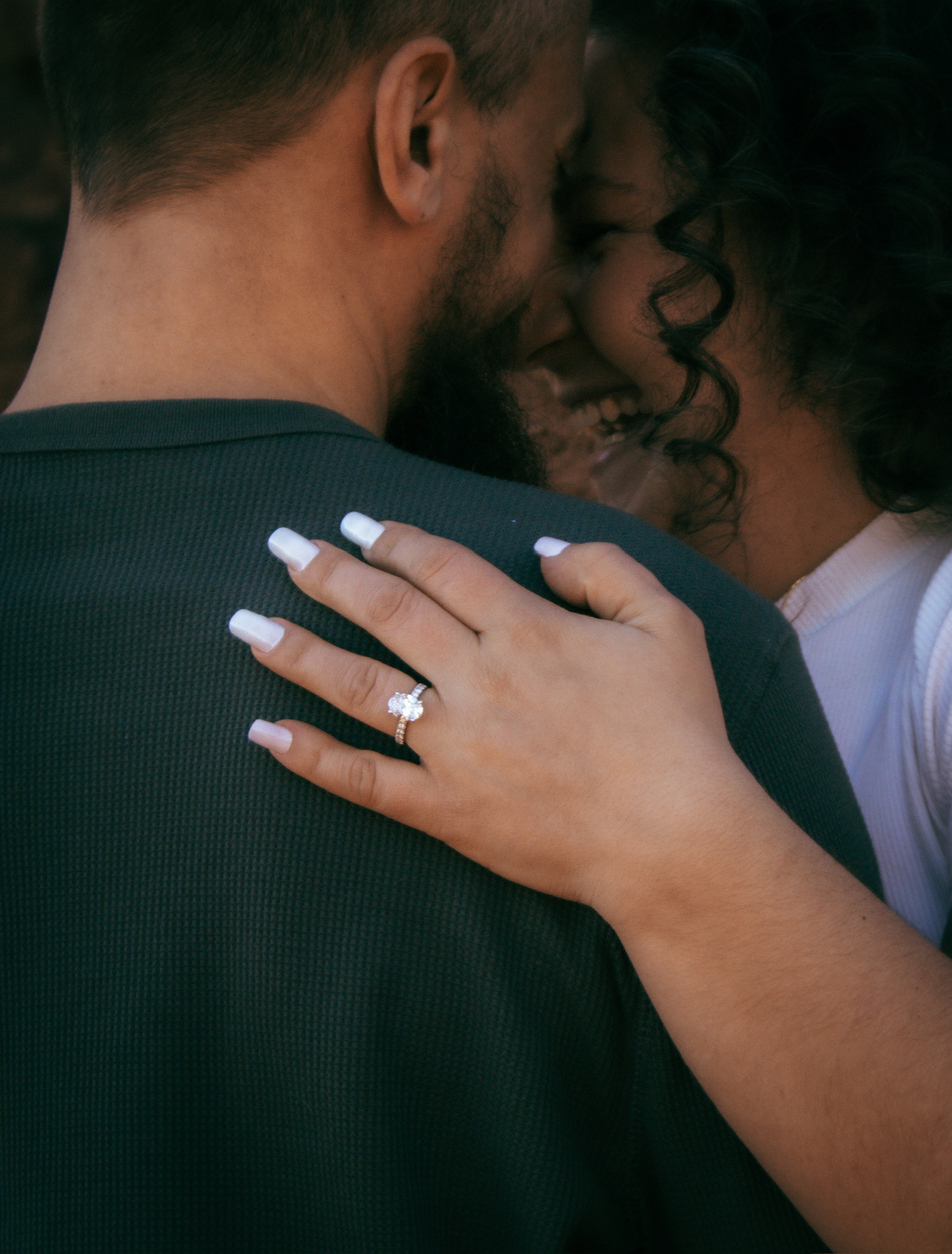Close-up of Emirjeta's engagement ring as they hold each other