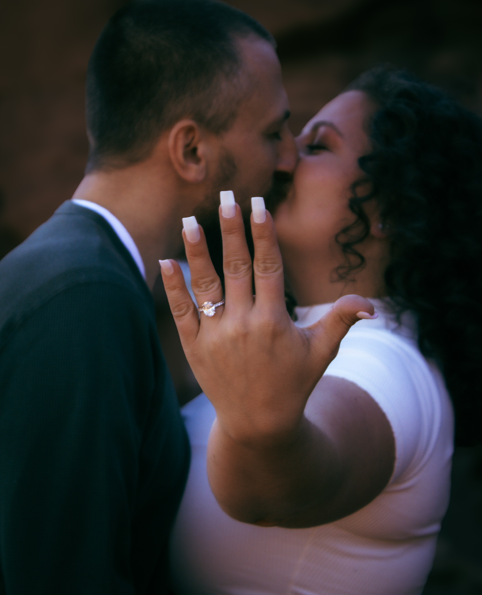 Adam and Emirjeta sharing a kiss with the engagement ring in view