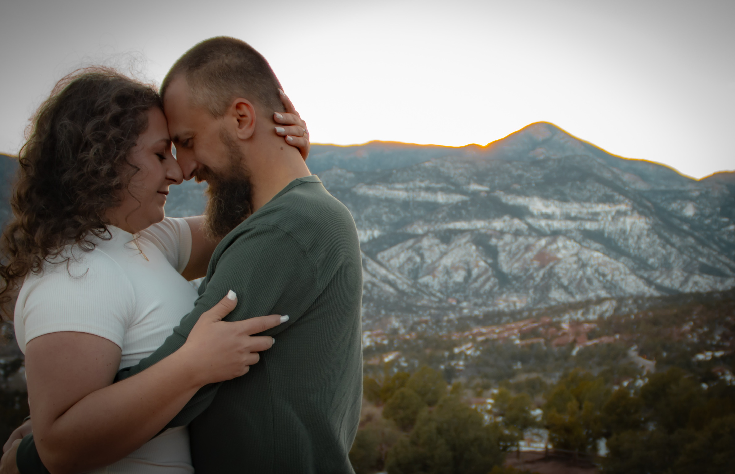Adam and Emirjeta with the snowy Colorado mountains behind them